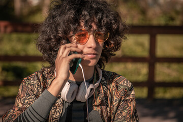 Wall Mural - young man afro hair talking with mobile phone