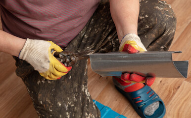 A man cuts a metal profile