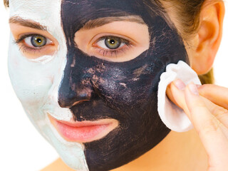 Wall Mural - Girl remove black white mud mask from face