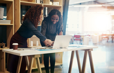 Poster - Use internet advertising to supplement newspaper and radio advertising. two businesswomen discussing something on a laptop at the office.