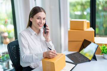 Startup, delivery and shipping in boxes for online shopping business. Businesswoman packing products from online business in a box to ship to clients and buyers.business woman working in the office