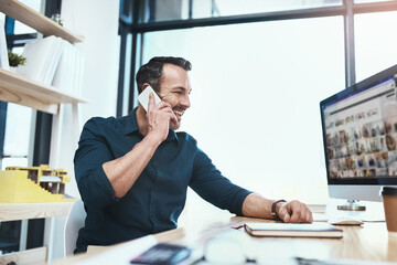 Aufkleber - Im calling with good news. a mature businessman talking on his phone while looking at his computer.