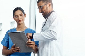 Canvas Print - This patients vitals look good. two young doctors using a digital tablet in a modern hospital.