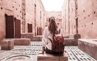 Wall Mural - Woman tourist visiting old ruin palace ( Palais El Badi) in Marrakech, Morocco