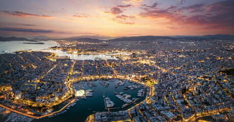 Wall Mural - aerial panorama of the illuminated piraeus district in athens, greece, with zea marina and the ferry
