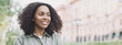 © kite_rin - Young woman in a city looking away, African-american student girl portrait, Young businesswoman smiling outdoor, Panoramic banner with copyspace