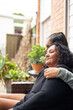 © Austockphoto - Teenage Aboriginal girl siting with her mum together on a garden bench