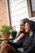 © Austockphoto - Teenage Aboriginal girl siting with her mum together on a garden bench