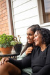 © Austockphoto - Teenage Aboriginal girl siting with her mum together on a garden bench