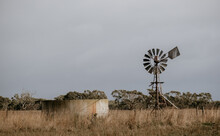 Windmill And Water Tank On A Farm.
