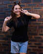 © Austockphoto - teen girl with space buns posing with peace signs