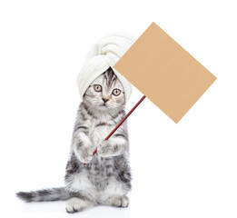Poster - Funny kitten with towel on it head stands on hind legs and shows empty placard. isolated on white background