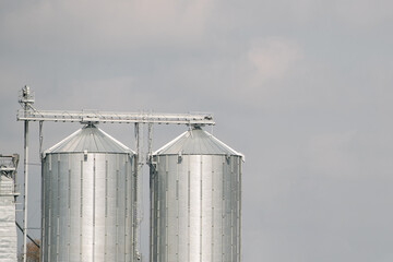 Wall Mural - Sillos with grain in the field. Agricultural Silos for storage and drying of grains, wheat, corn, soy, and sunflower.