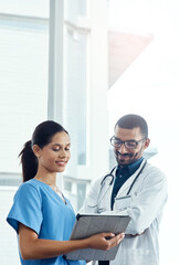 Poster - Smart doctors use smart technology. two young doctors using a digital tablet in a modern hospital.