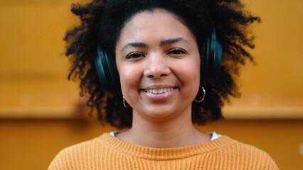 Wall Mural - Black woman, portrait or music headphones on isolated yellow background, fashion mockup or wall mock up. Smile, happy or laughing student listening to radio, audio and podcast in trendy or cool cloth