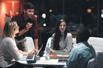 Poster - Going the extra mile makes things happen. colleagues having a meeting during a late night in a modern office.