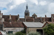 medieval, red tiled roofs and tower of church in the village of Saulieu in the French region of the Bourgogne