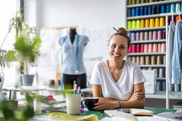 Wall Mural - Young fashion designer at her workplace
