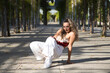 © @skuder_photographer - Latin woman, young and beautiful dancing modern dance in the street in a park and makes different expressions and postures. Concept dance, hip hop, dance, art, action, beauty, youth art.