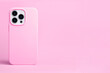 pink phone case mockup. iPhone 14 pro max and 13 mock up back view isolated on pink background, banner with place for text on the right in monochrome colors