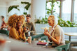 © bernardbodo - Cheerful businesswomen eating at work.