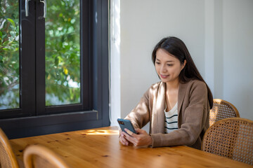 Canvas Print - Woman use mobile phone inside coffee shop