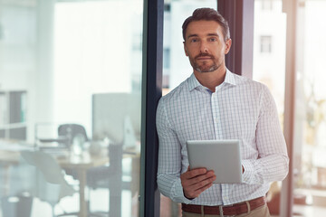 Canvas Print - Hard work is essential to success. Portrait of a businessman using a digital tablet in an office.