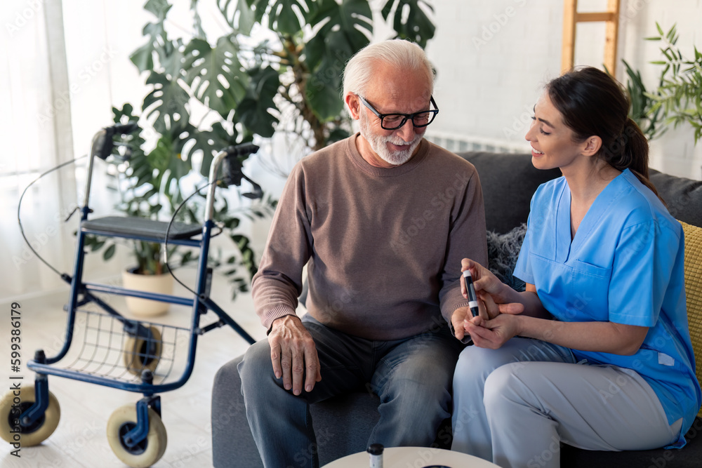 Nurse poking patient's finger with needle pen to measure blood sugar. Senior man having his blood sugar measured at home by his caregiver. Elderly man and healthcare specialist during home visit.