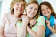 © GR/peopleimages.com - Its just the girls today. A beautiful mature woman being hugged by her mother and daughter.