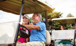 Arriving in style. an affectionate mature couple spending a day on the golf course.
