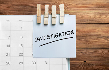 Poster - blue sticker attached to a calendar on a wooden background with text investigation