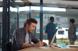 © GR/peopleimages.com - He doesnt shy away from hard work. a businessman working in his office.