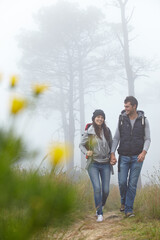 Wall Mural - Hiking hand in hand. Full length shot of a young couple hiking along a nature trail.