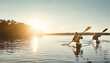 © GR/peopleimages.com - Make memories on the water. a young couple kayaking on a lake outdoors.