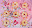 donuts with sprinkles on pink background