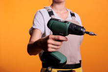 Construction Worker Holding Cordless Drilling Gun Over Background, Advertising Electric Power Drill Nail Gun Used In Building And Refusrbishment Project. Screwing Gun And Renovating Tools. Close Up.