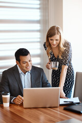 He appreciates her input. two young businesspeople working together in a modern office.