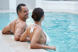 © Nicola Katie/peopleimages.com - Having fun in the pool with a beautiful girl. a couple relaxing in a pool.