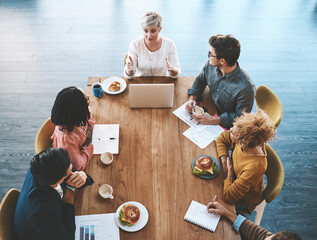 Canvas Print - The most productive teams do it together. a group of young businesspeople having a meeting in a modern office.