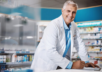 Poster - Im in the service of bettering lives. a male pharmacist writing on a clipboard in a drugstore.