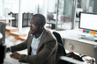 © GR/peopleimages.com - Success is one click away. a young businessman working on his computer at his desk.