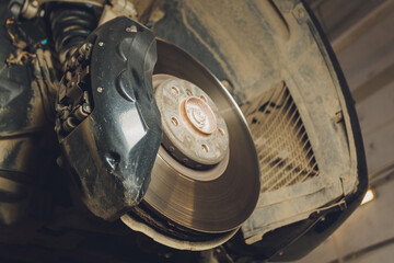 Brake disk and caliper assembly on a modern car about to be replaced.