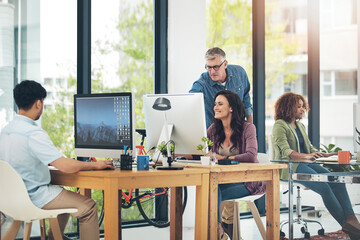 Aufkleber - He makes it look so easy. group of creative colleagues working on a project together in their office.