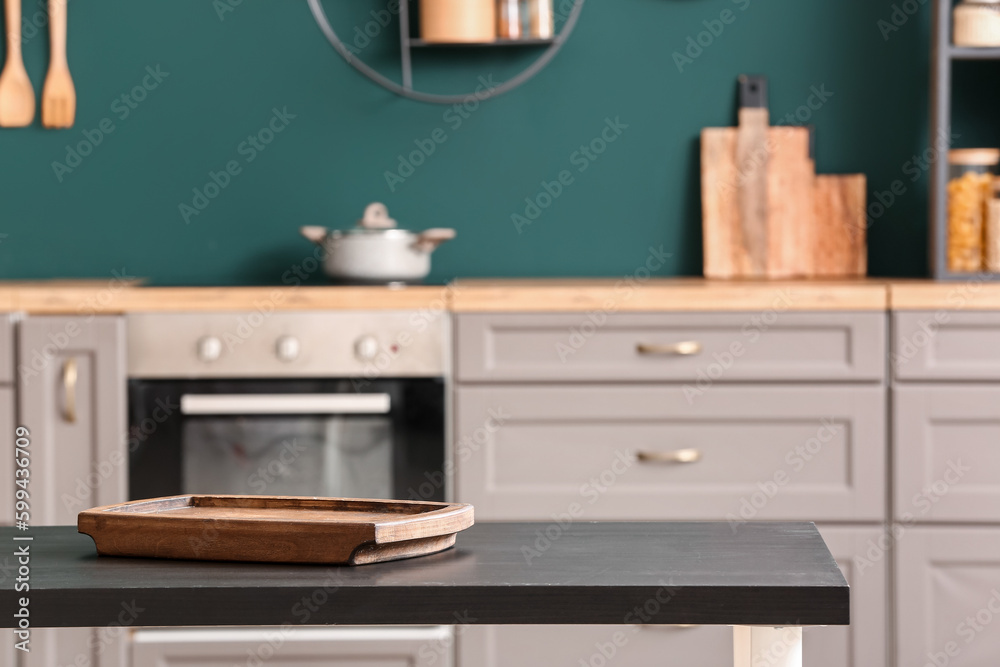 Wooden tray on black table in kitchen