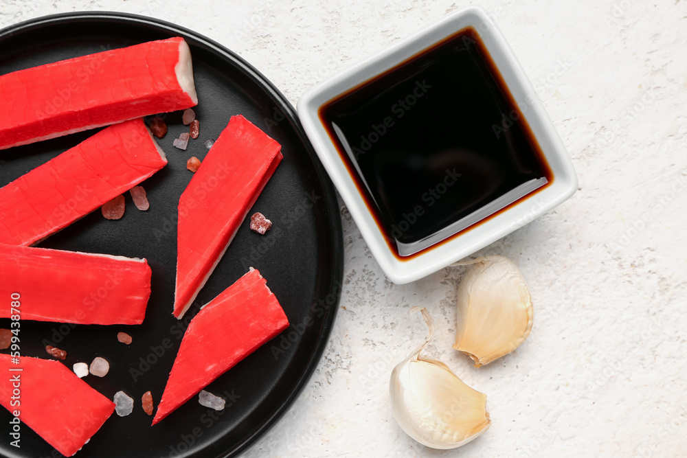 Plate with tasty crab sticks and sauce on light background, closeup