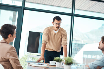 Poster - Hes got some important points to lay out. a young businessman giving a presentation to his colleagues in an office.