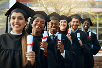 Poster - The start of many more successes to come. Portrait of a group of young students holding their diplomas on graduation day.