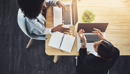 Poster - Coming up with a new plan. High angle shot of two businesswomen having a discussion in an office.
