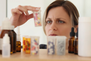 Woman looks for bottle with pills to handle acute headache