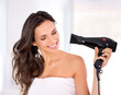 © Yuri Arcurs/peopleimages.com - Drying my hair takes a while... but I love it. A beautiful woman drying her hair with a hairdryer.